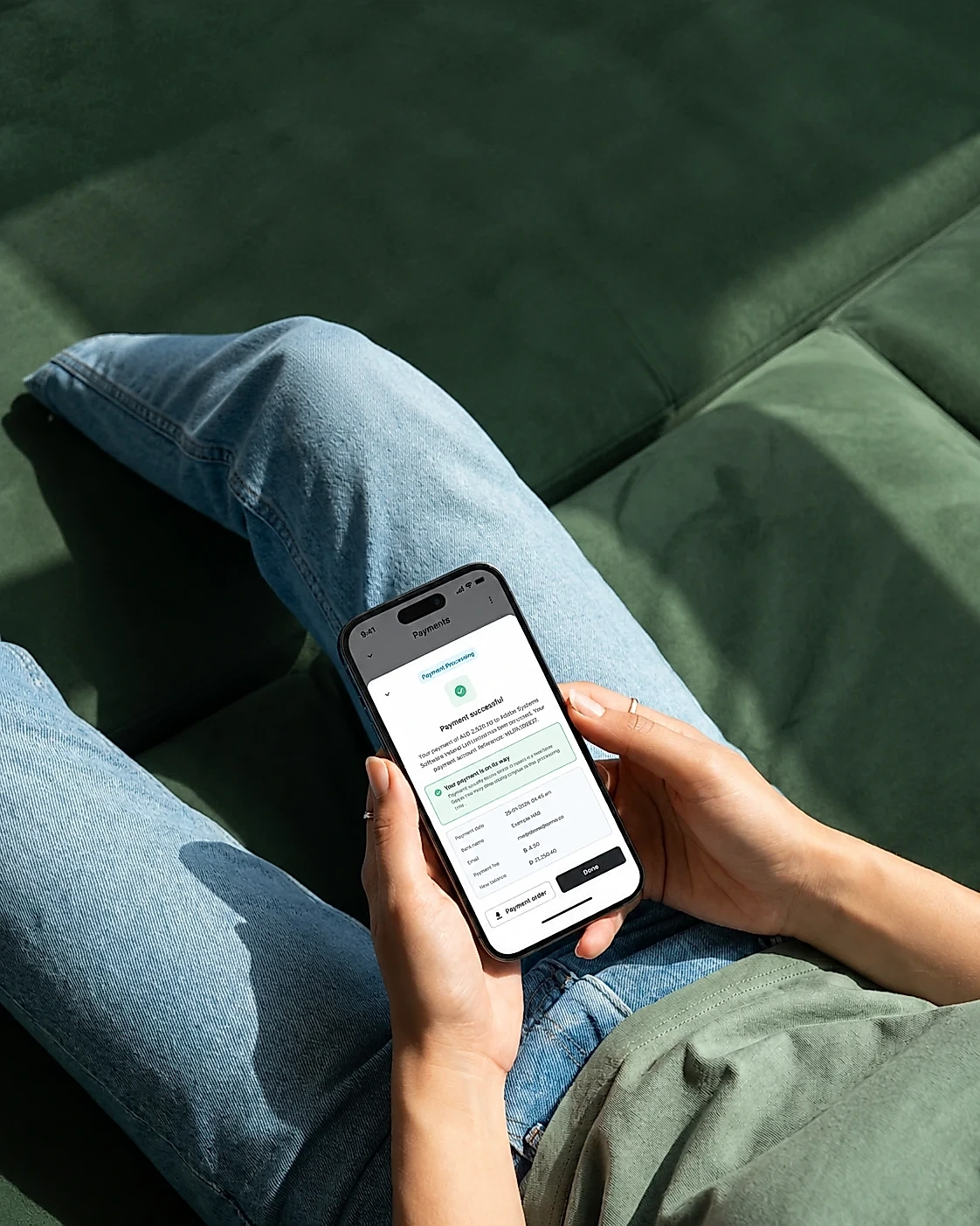 Someone holding a phone showing a payment successful screen in the Pemo app