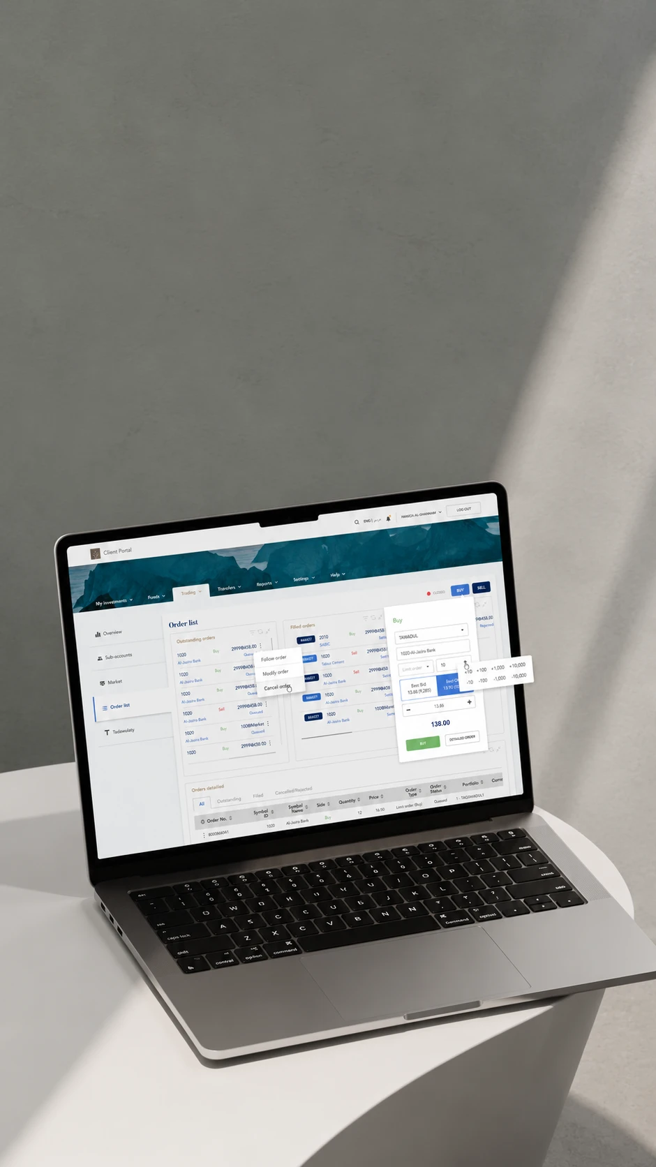The redesigned Jadwa client portal on a laptop, showing the order list and a buy ticket